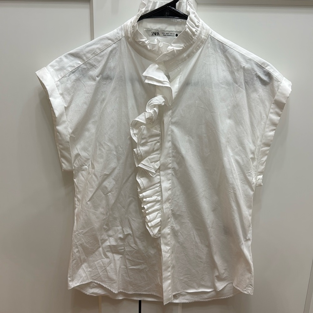 White ruffled sleeveless top